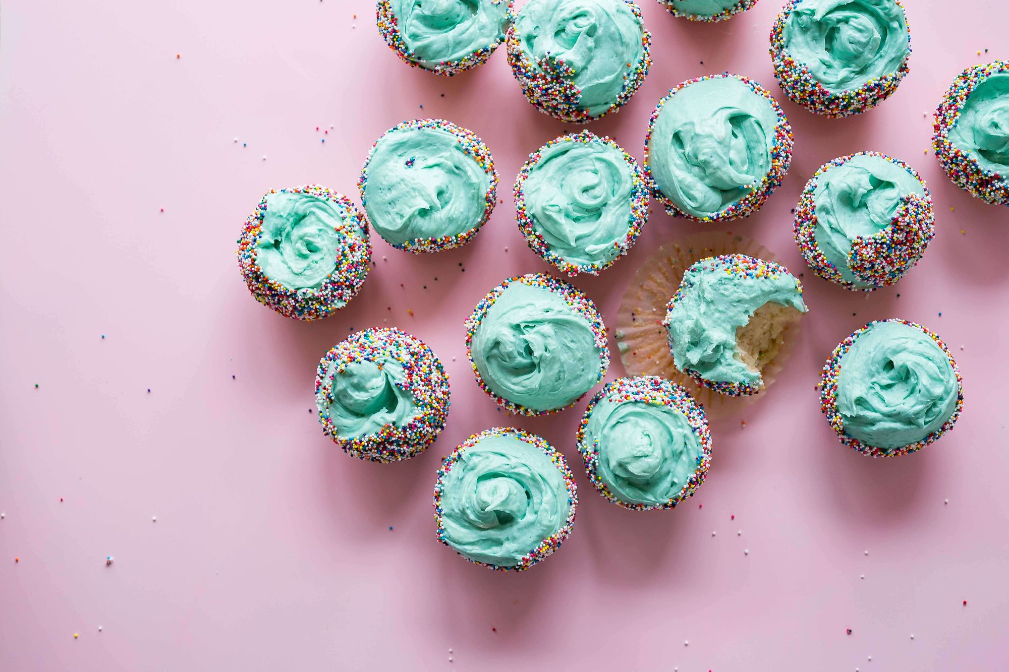 Cupcakes with blue icing and one with a bite out of it