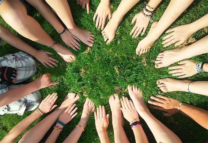 Hands and feet on grass making a circle