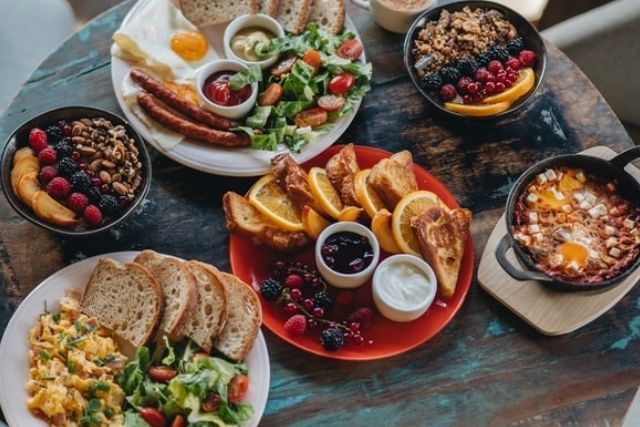 Different and colourful breakfast dishes set out on a table in a cafe or restaurant