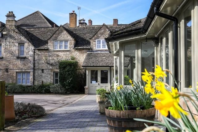 Exterior of Stratton House Hotel & Spa with wooden tubs of daffodils in the foreground
