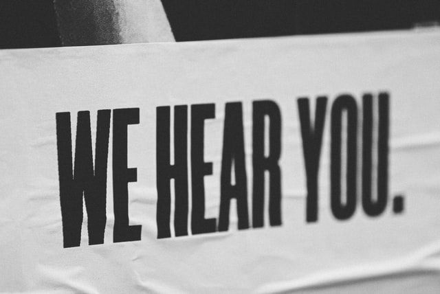 Black and white paper notice with 'We Hear You' written in bold, black type.