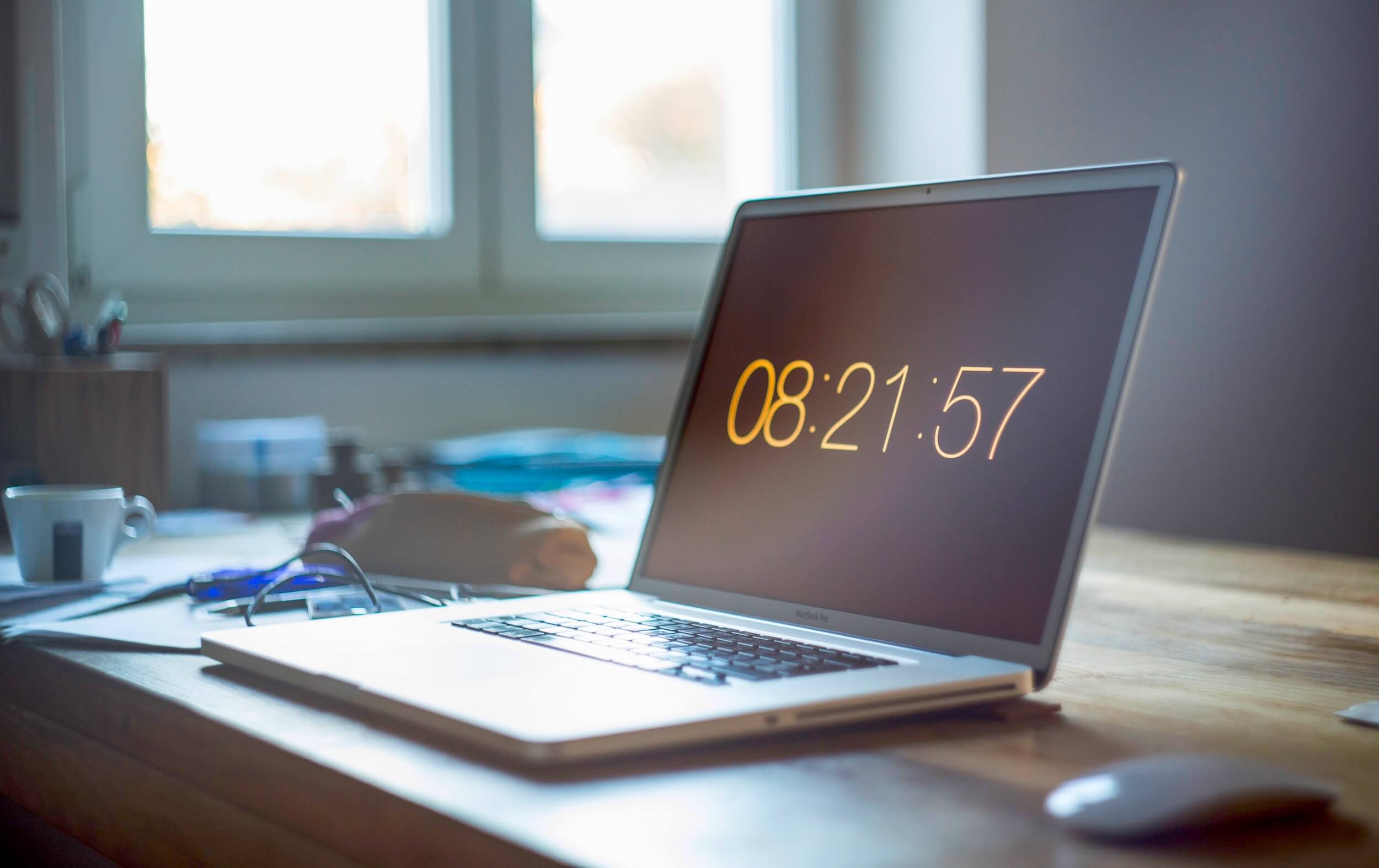 Close-up photo of a laptop on a desk displaying a countdown clock.