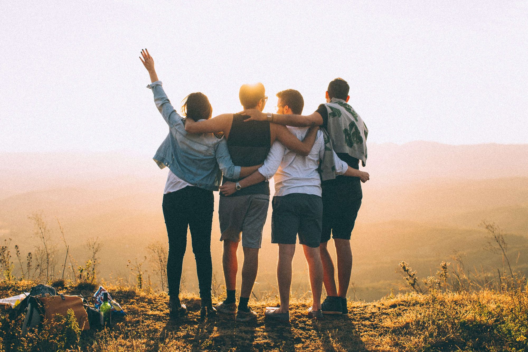 Photo of four team members overlooking a landscape at sunset