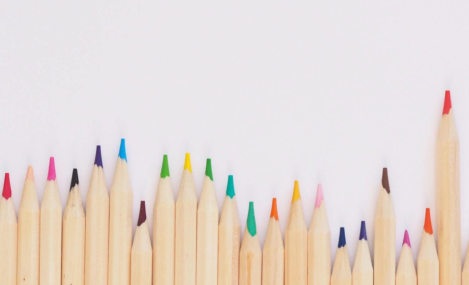 Close-up photo of a row of wooden coloured pencils