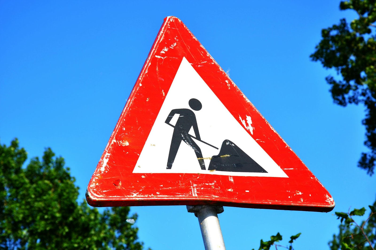 A triangular 'Men at Work' road sign