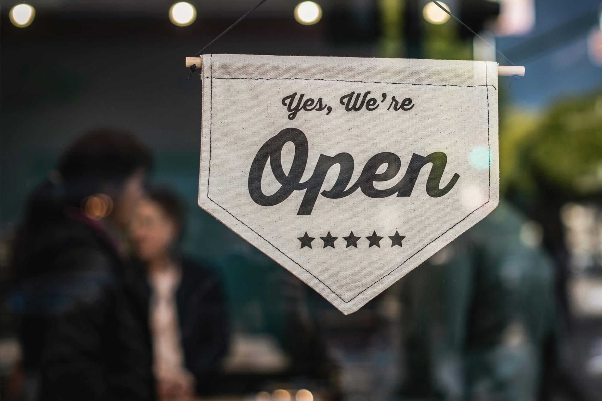 An open sign with five stars, reading: "Yes, we're open"